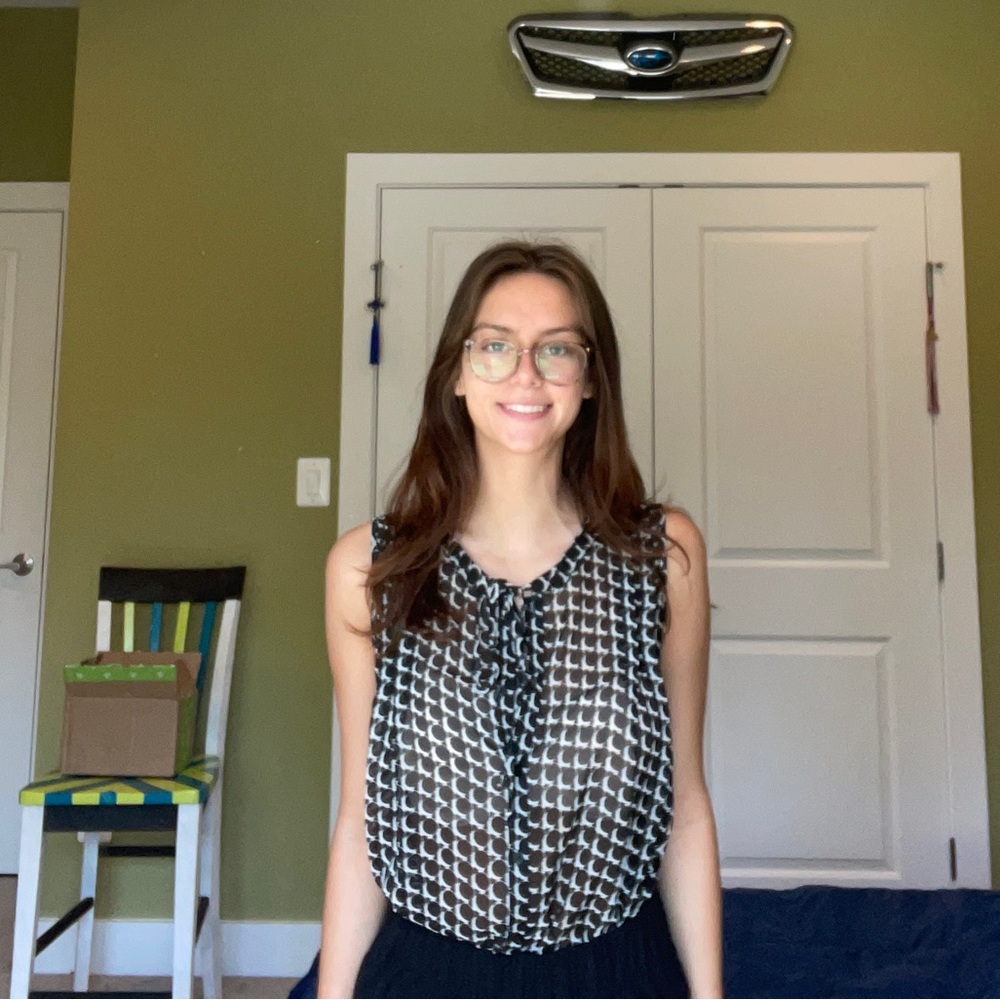 Black and white patterned sleeveless blouse.